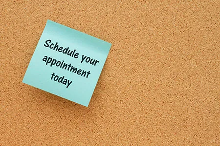 bulletin board with post it not saying schedule your appointment today